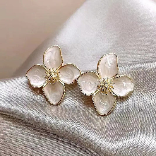 Vylaura oorbellen met een verfijnd bloemenontwerp en parelmoer glans. Deze elegante oorbellen voegen een subtiele en romantische touch toe aan elke look. Perfect voor speciale gelegenheden of als tijdloos sieraad voor dagelijks gebruik.